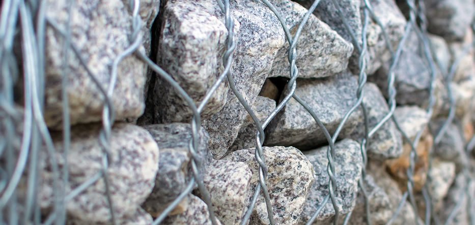Twisted gabions filled with natural stones are used to reinforce embankments